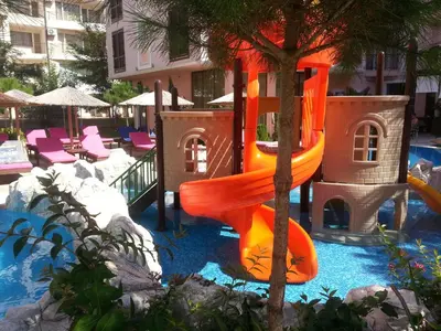 a slide in a playground in a resort at Menada Romance Marine Apartments in Sunny Beach