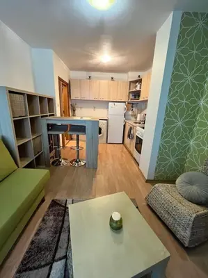 a living room with a couch and a table at Cosy apartment near the beach with terrace & sea view in Burgas City