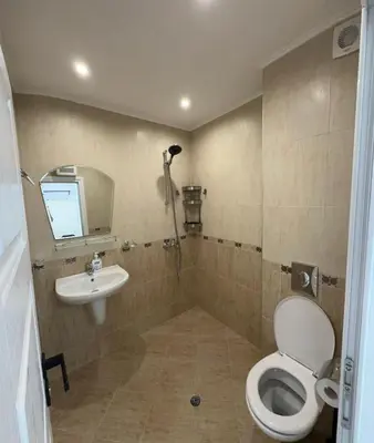 a bathroom with a toilet and a sink at Prestige Apartment 1 in Burgas City