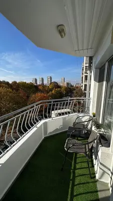 a balcony with a table and chairs on a building at Prestige Apartment 1 in Burgas City