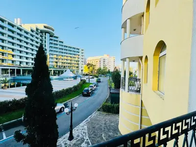 a city street with cars parked on the side of a building at VICTORIA RESIDENCE Two Bedroom Sunny Beach in Sunny Beach
