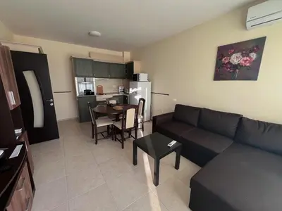 a living room with a couch and a table at Sunset Apartment Pomorie in Pomorie