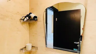 a mirror on a wall with a door and a sink at Amara В 10 Sunny Beach in Sunny Beach
