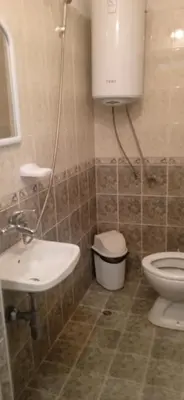 a bathroom with a sink and a toilet at Къща за гости in Primorsko