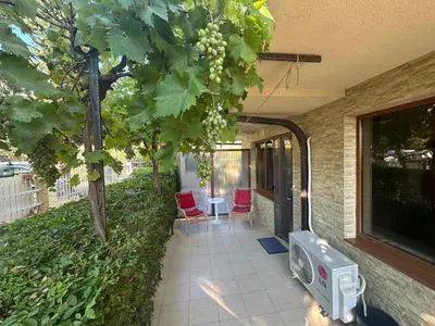 a patio with a tv and a table and chairs at Apartment Sunny Seasons Byala in Byala