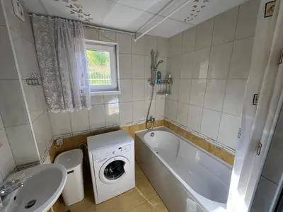a bathroom with a washing machine next to a sink at Apartment Sunny Seasons Byala in Byala