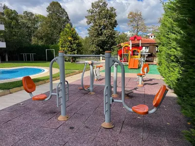 a playground with orange chairs next to a pool at Apartment Sunny Seasons Byala in Byala