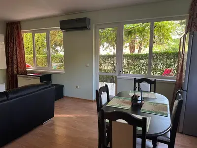 a living room with a table and a couch at Apartment Sunny Seasons Byala in Byala