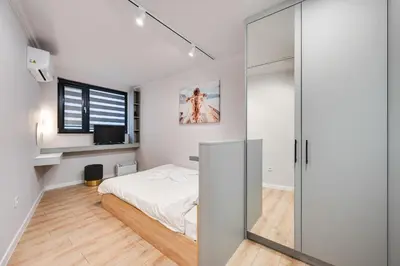 a bedroom with a bed and a sliding glass door at Central Apartments with Patio Close to Sea in Varna City