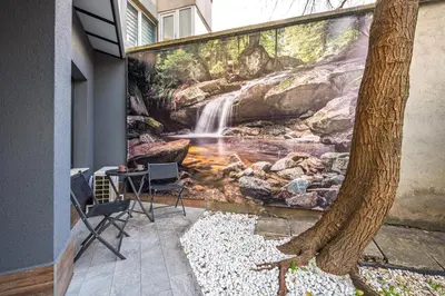 a waterfall mural on the side of a building at Central Apartments with Patio Close to Sea in Varna City