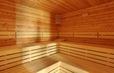 a large wooden sauna with wooden floors and ceilings at Apartment Victoria Hotel & SPA Aheloy in Kableshkovo