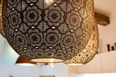 a close up of a black and gold light fixture at Studio in the Center of Burgas next to the See in Burgas City