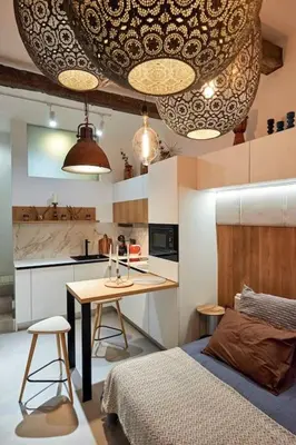 a small kitchen with a table and a bed in a room at Studio in the Center of Burgas next to the See in Burgas City