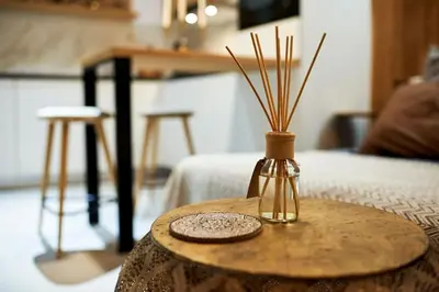 a small table with a bottle on top of it at Studio in the Center of Burgas next to the See in Burgas City