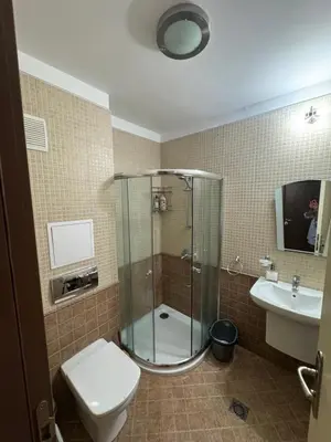 a bathroom with a shower and a toilet and a sink at Heritage in Oasis Resort Lozenets in Lozenets