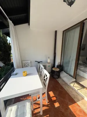 a white table and chairs on a patio at Heritage in Oasis Resort Lozenets in Lozenets