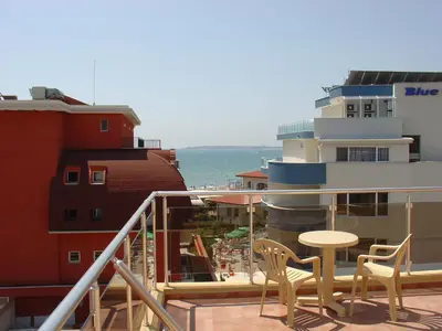 a balcony with chairs and a table on a building at Sunny Flower Family Hotel in Sunny Beach