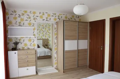a bedroom with a closet and a dresser at Vello Apartments in Byala
