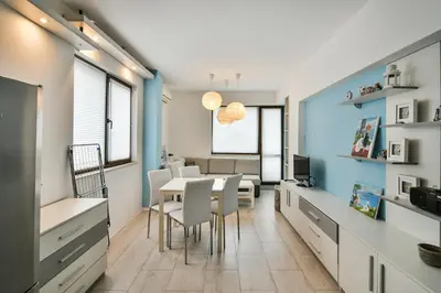 a kitchen and dining room with a table and chairs at Central gem for 2 next to beach in Varna City