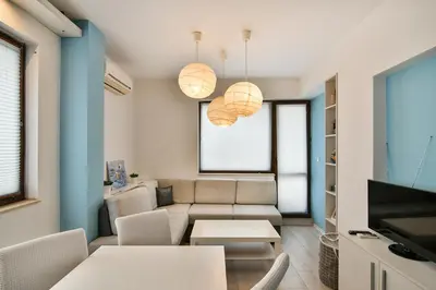 a living room with a couch and a table at Central gem for 2 next to beach in Varna City