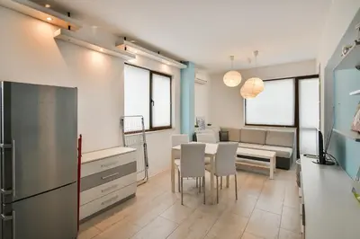 a kitchen and dining room with a table and chairs at Central gem for 2 next to beach in Varna City