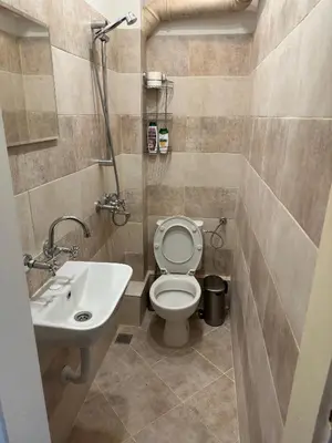 a bathroom with a toilet and a sink at Something In French in Burgas City