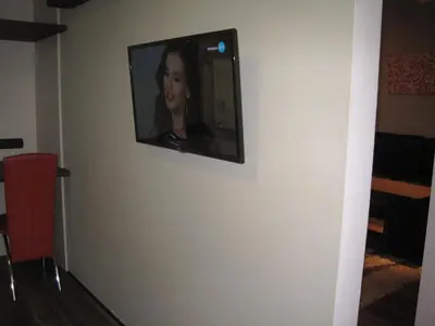 a television on a wall in a room at Apartment Alegria in Varna City