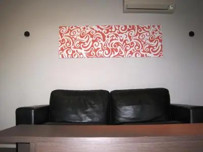 a couch in a room with a painting on the wall at Apartment Alegria in Varna City