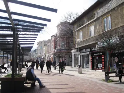 a group of people walking down a city street at Apartment Alegria in Varna City