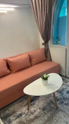 a living room with a couch and a table at Sunrise Sea Garden in Burgas City