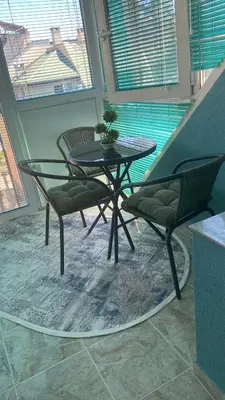 a table and two chairs with a plant on it at Sunrise Sea Garden in Burgas City