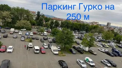 a parking lot full of cars in a city at Sunrise Sea Garden in Burgas City