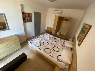 a bedroom with a large bed in a room at White Pearl Apartment Sozopol in Sozopol