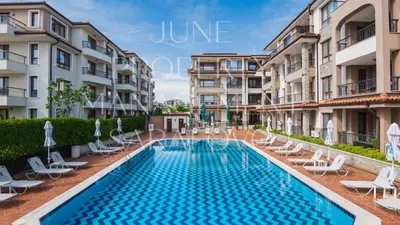an image of a swimming pool in front of some apartment buildings at Zerini Apartment in Burgas City
