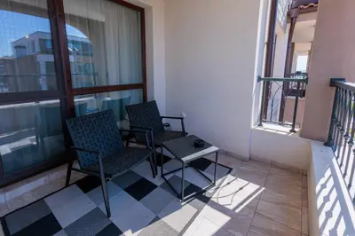 two chairs and a table sitting on a balcony at Zerini Apartment in Burgas City