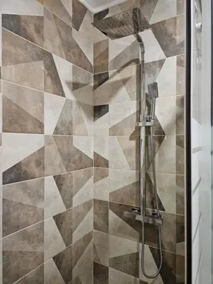 a shower with a shower head in a bathroom at Zerini Apartment in Burgas City