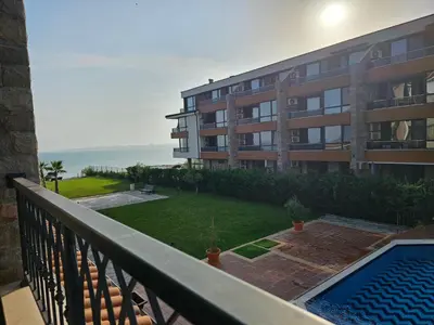 a balcony of a building with a swimming pool at Zerini Apartment in Burgas City