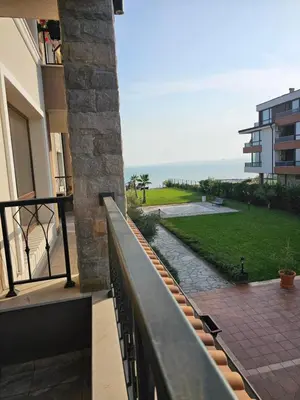 a balcony of a building with a view of the ocean at Zerini Apartment in Burgas City