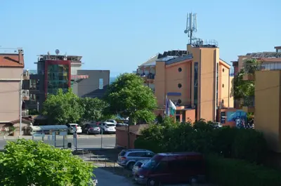 a city with cars parked in a parking lot at Divela 3 Apartments in Nesebar