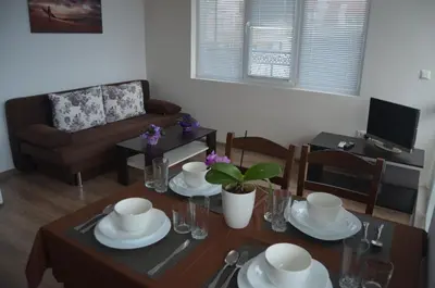 a living room with a table and a couch at Divela 3 Apartments in Nesebar