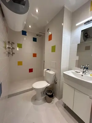 a bathroom with a toilet and a sink at Burgas in Burgas City