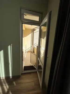 a glass door leading to a hallway with a staircase at Burgas in Burgas City