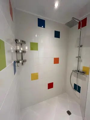 a bathroom with colorful tiles on the wall at Burgas in Burgas City