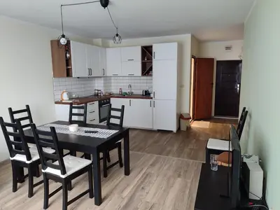 a kitchen and dining room with a table and chairs at Burgas in Burgas City