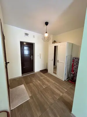an empty living room with a door and wooden floors at Burgas in Burgas City