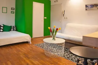 a living room with a vase of flowers on a table at Varna Heart Studio in Varna City