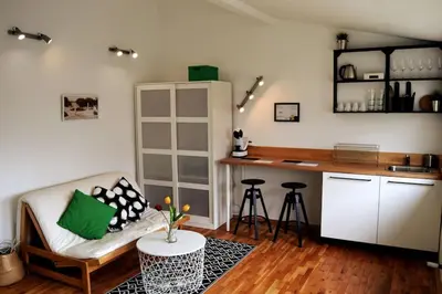 a living room with a couch and a kitchen at Varna Heart Studio in Varna City