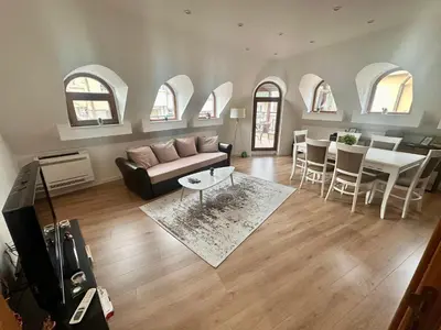 a living room with a couch and a table at Deluxe Apartment Burgas City Centre with Free Parking in Burgas City