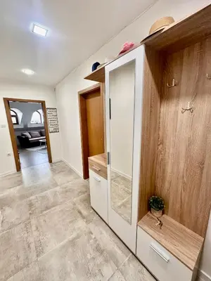 a living room with a large white cabinet at Deluxe Apartment Burgas City Centre with Free Parking in Burgas City