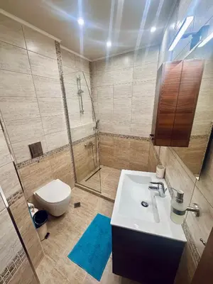a bathroom with a sink and a shower and a toilet at Deluxe Apartment Burgas City Centre with Free Parking in Burgas City